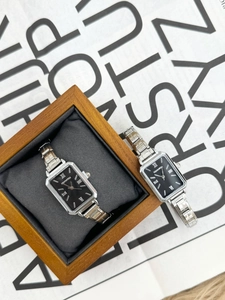 Detail of elegant rectangular quartz watches with silver stainless steel link bracelets