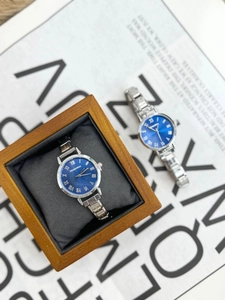 Detail of blue sunray watch dial with roman numerals and elegant wooden gift box