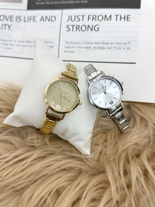Detail of luxury ladies watches with sparkling dials and metallic link bracelets