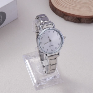 Detail showing the polished silver-tone metal strap and quartz watch face for women