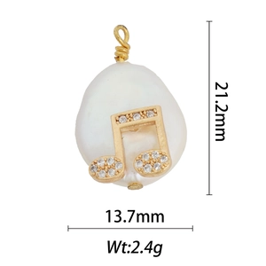 Detailed view of musical note pearl pendant with 18k gold plating and zircon inlay