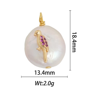 Detail view of 18k gold bird pendant with pink gems and pearl measuring 18.4mm