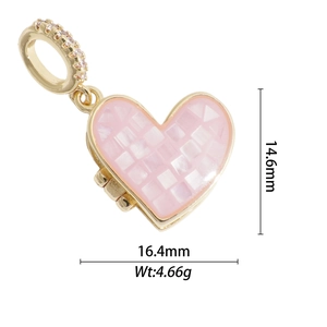 Macro shot of 18k gold heart locket with pink shell inlay and pavé crystals