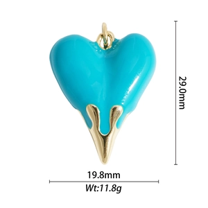 Macro view of blue enamel heart pendant showing 29mm height and gold metal frame details