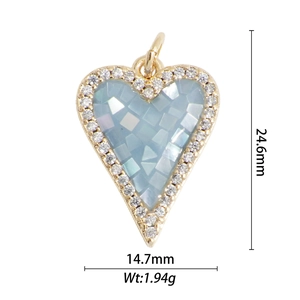Macro detail of a 18k gold plated heart cross pendant with zircon and blue shell inlay