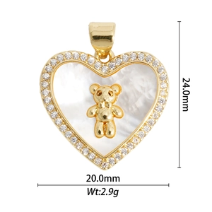 Detailed view of gold lava heart pendant with mother of pearl, bear motif and dimensions