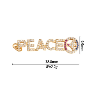 Pendentif lettre PEACE doré serti de zircons blancs et pierres précieuses colorées
