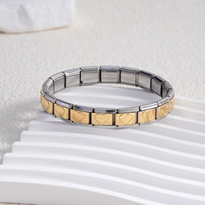 Italian modular stainless steel bracelet with gold heart charms on a white display