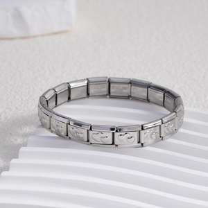 Detailed macro shot of modular stainless steel bracelet with double heart embossed charms