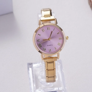 Detail view of a gold quartz watch with a purple sunray dial and Roman numeral markers