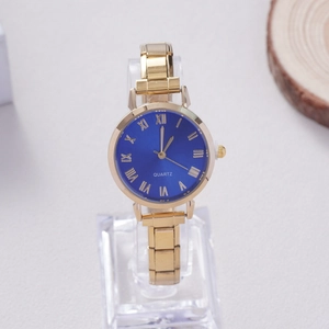 Detailed close-up of blue sunray dial with Roman numerals and golden metal link bracelet