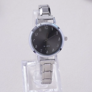 Close-up of elegant silver stainless steel quartz watch with dark grey numeric dial