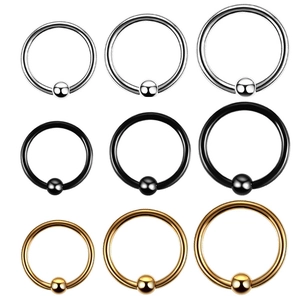 Detailed macro view of ball closure rings in silver black and gold stainless steel finish