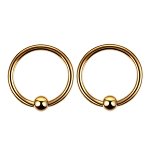 Detail shot of a pair of gold-plated captive bead rings with polished mirror finish