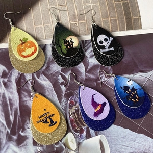 Detail of five pairs of stacked faux leather Halloween teardrop earrings with sequins