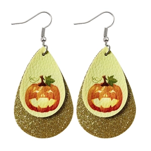 Detail of double-layer Halloween pumpkin earrings with glitter backing and leather texture