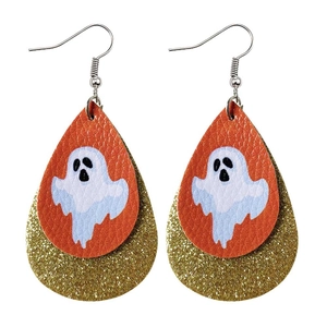 Close-up of double-layered teardrop earrings with orange leather and ghost pattern