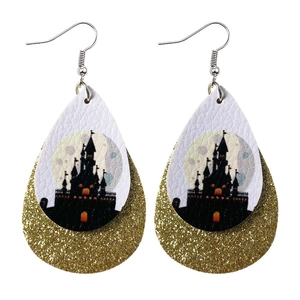 Detail of double-layer teardrop earrings with castle print and golden glitter finish