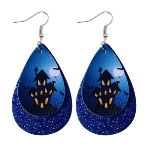 Detail of Halloween faux leather earrings with spooky castle and bat motifs on glitter layer