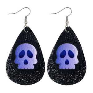 Detail of teardrop leather earrings with skull print and black glitter backing