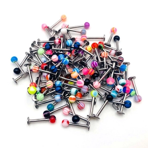 Macro view of colorful acrylic labret piercing studs with mixed marble patterns