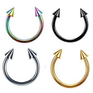 Detail of horseshoe nose rings in four metallic finishes including rainbow and gold