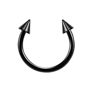 Macro shot of black stainless steel horseshoe ring with sharp spike ends for body piercing