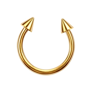 Detailed view of a golden stainless steel horseshoe piercing with sharp spike ends