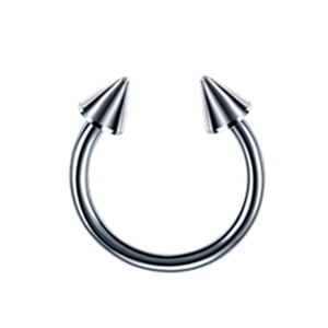 Macro view of silver horseshoe barbell piercing ring with sharp screw-on spike ends