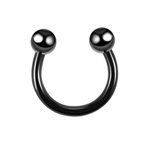 Close-up of black surgical steel horseshoe ring with two screw-on balls for body piercing