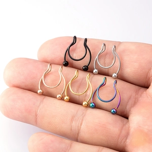 Five-color stainless steel faux nose ring set held in palm, showing U-shape ball design