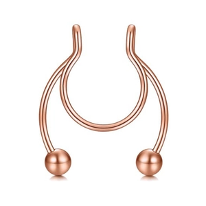 Detail of rose gold double-layered septum ring with polished metal spheres for piercing