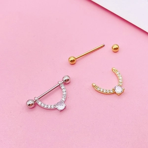 Detail of stainless steel heart nipple shields with zircon in gold and silver finish