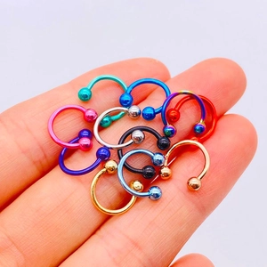 Colorful stainless steel circular barbell piercing set with various metallic finishes