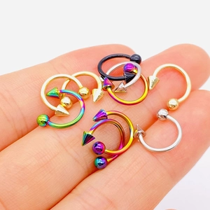 Stainless steel horseshoe rings in various colors held on fingers for size detail