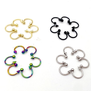 Macro view showing stainless steel horseshoe rings in four colors with ball and spike ends