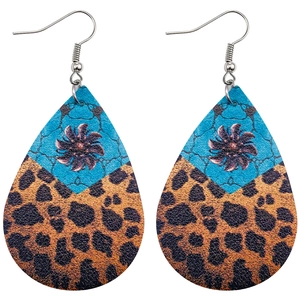 Détail de boucles d'oreilles bohèmes en goutte avec imprimé léopard et texture pierre