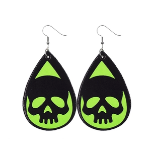 Close-up of teardrop leather earrings featuring green glow-in-the-dark skull patterns