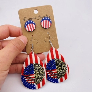 Detail view of Independence Day earrings with American flag patterns and sunflower designs