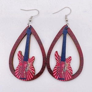 Macro detail of teardrop wooden earrings featuring red guitar silhouette and striped patterns