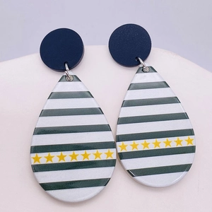 Green and white striped acrylic drop earrings with yellow stars and blue circular studs