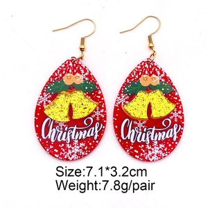 Detail view of red teardrop Christmas earrings with golden bells and size specifications
