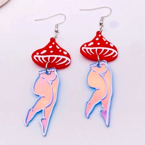 Macro shot of acrylic mushroom earrings with laser-effect bikini girl leg charms