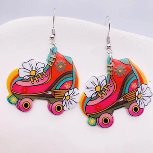 Detailed macro view of retro roller skate acrylic drop earrings with colorful rainbow stripes