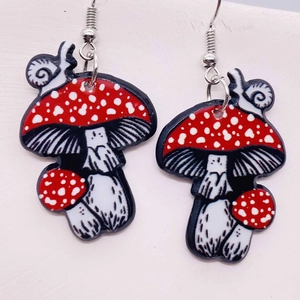 Detailed view of handmade cartoon mushroom and snail acrylic dangle earrings