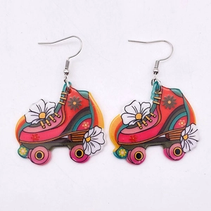 Colorful acrylic roller skate earrings with retro daisy print and pop art style