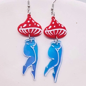 Close-up of surreal acrylic mushroom earrings with blue gradient female leg charms