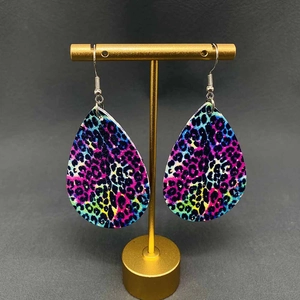 Neon leopard print teardrop leather earrings on golden display stand for women