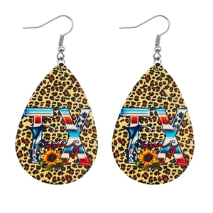 Detail view of teardrop earrings featuring leopard print, Texas letters, and sunflowers
