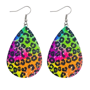 Close-up of teardrop faux leather earrings featuring rainbow leopard print pattern